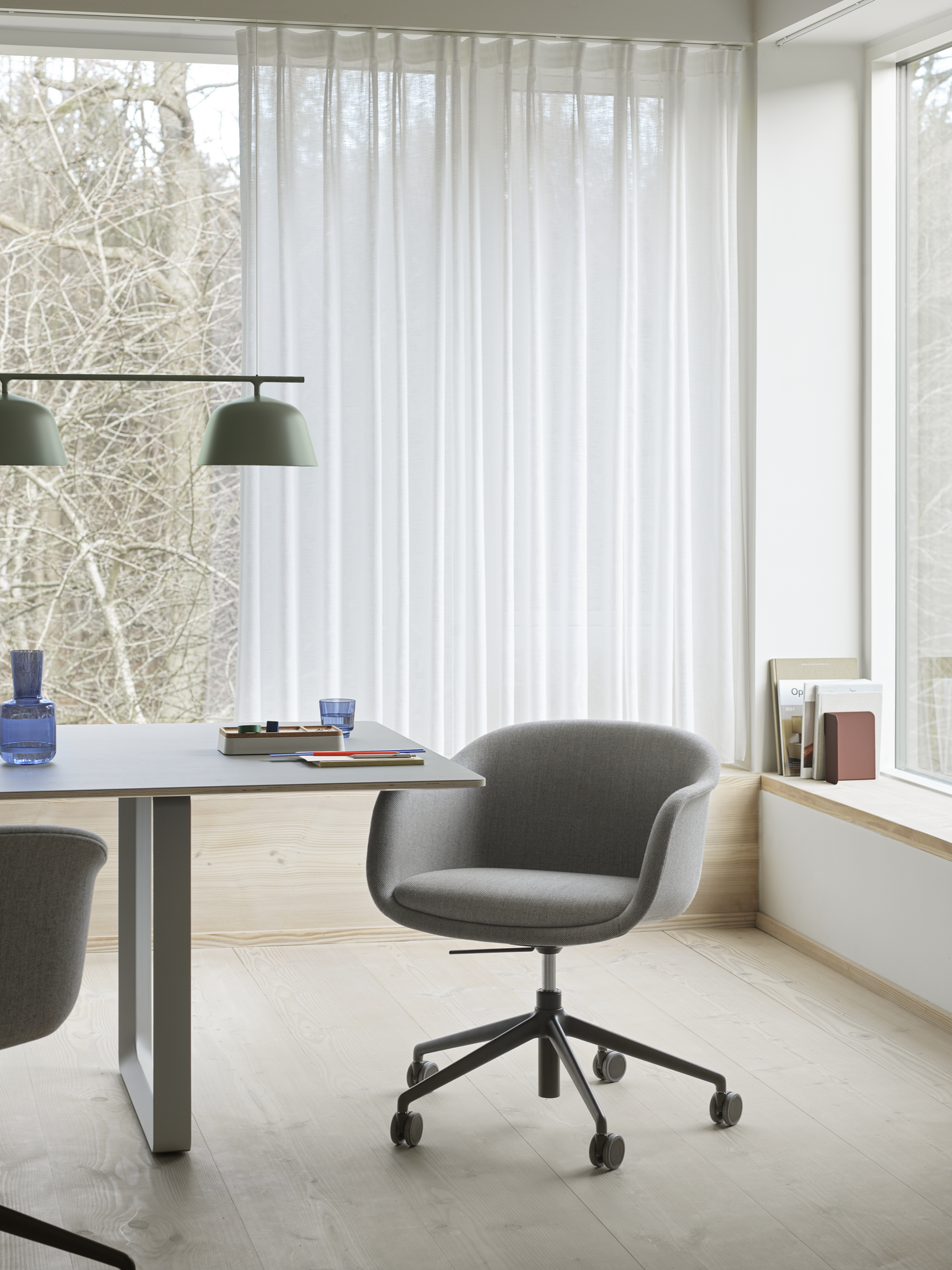 Fiber Conference Armchair - 70/70 Table in Grey - Ambit Rail Lamp in Dusty Green - Raise Carafe & Glasses in Dark Blue - Arrange