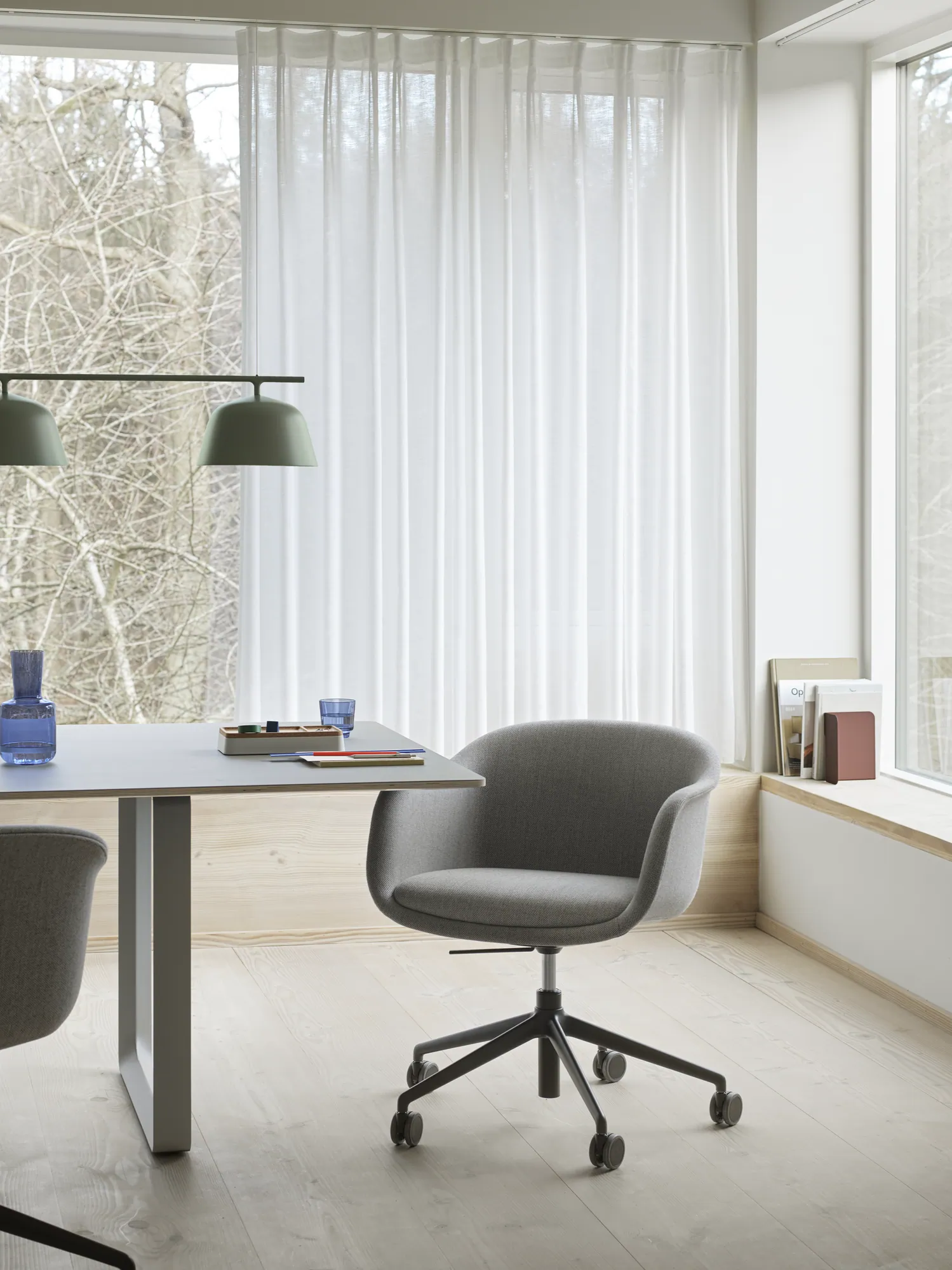 Fiber Conference Armchair - 70/70 Table in Grey - Ambit Rail Lamp in Dusty Green - Raise Carafe & Glasses in Dark Blue - Arrange