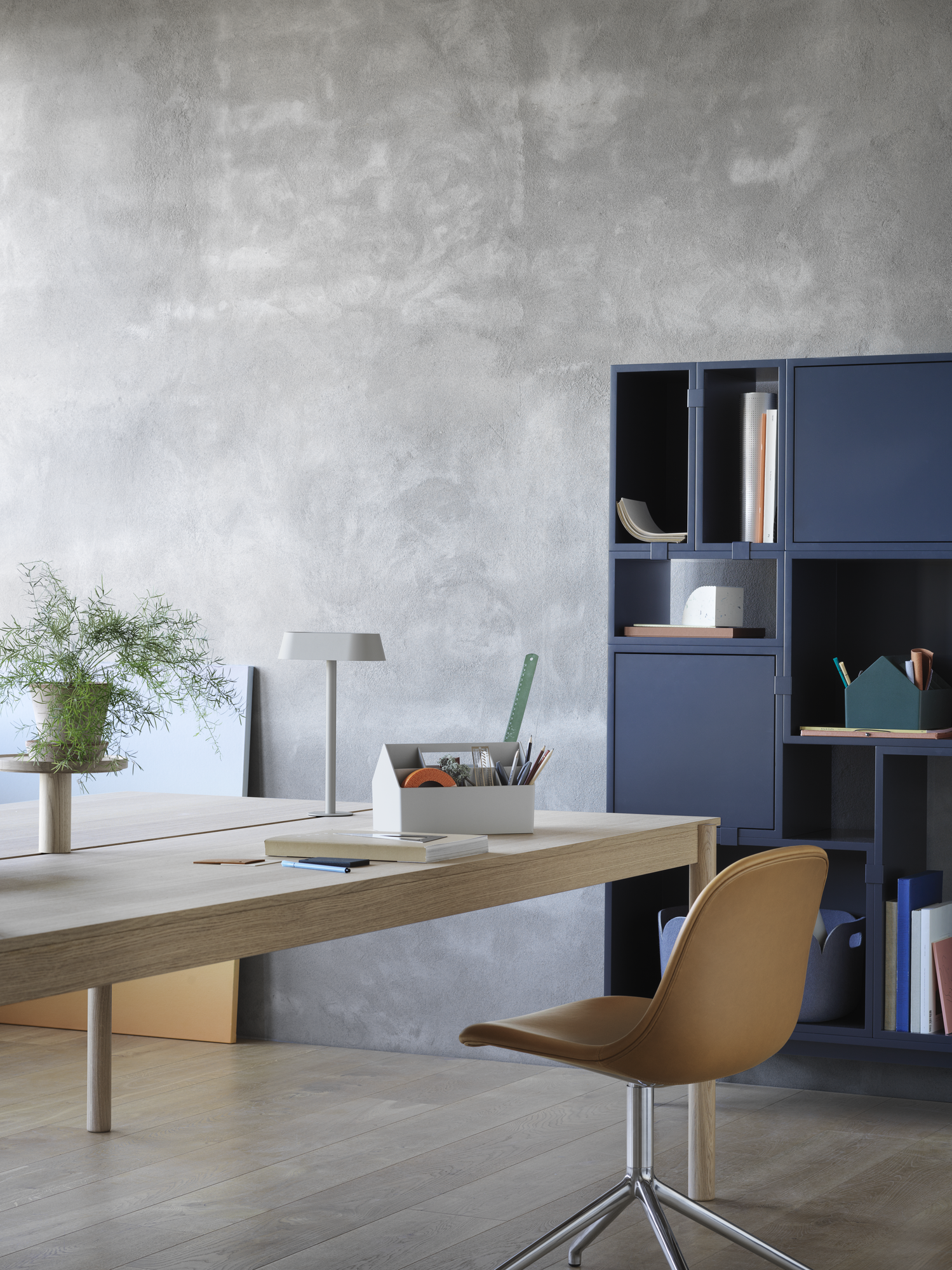 Linear System Modular Table in Oak, Linear Lamp Series, Linear System Tray, Fiber Side Chair Swivel Base in Aluminum & Cognac Refine Leather, Stacked Storage System in Midnight Blue