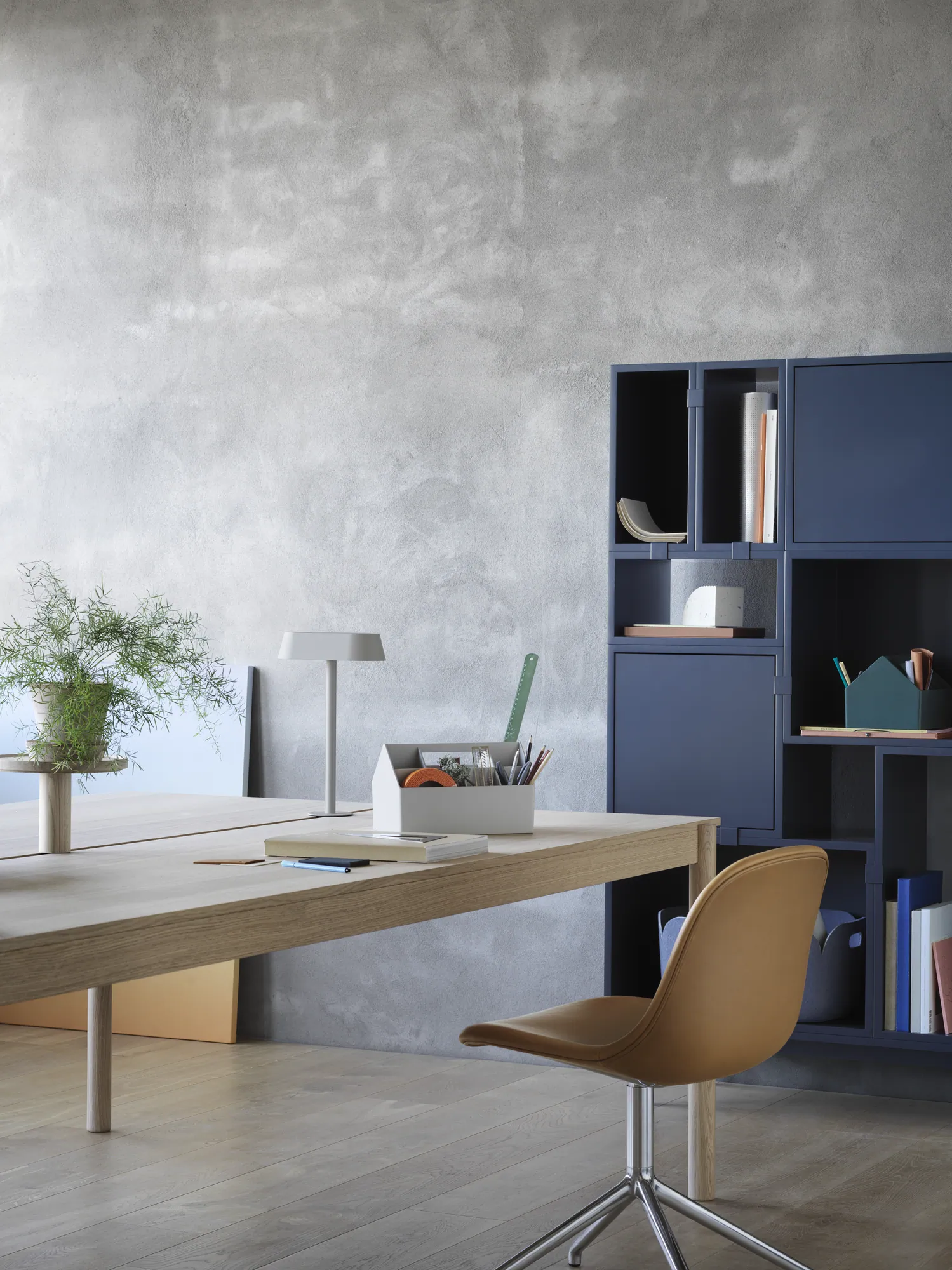 Linear System Modular Table in Oak, Linear Lamp Series, Linear System Tray, Fiber Side Chair Swivel Base in Aluminum & Cognac Refine Leather, Stacked Storage System in Midnight Blue