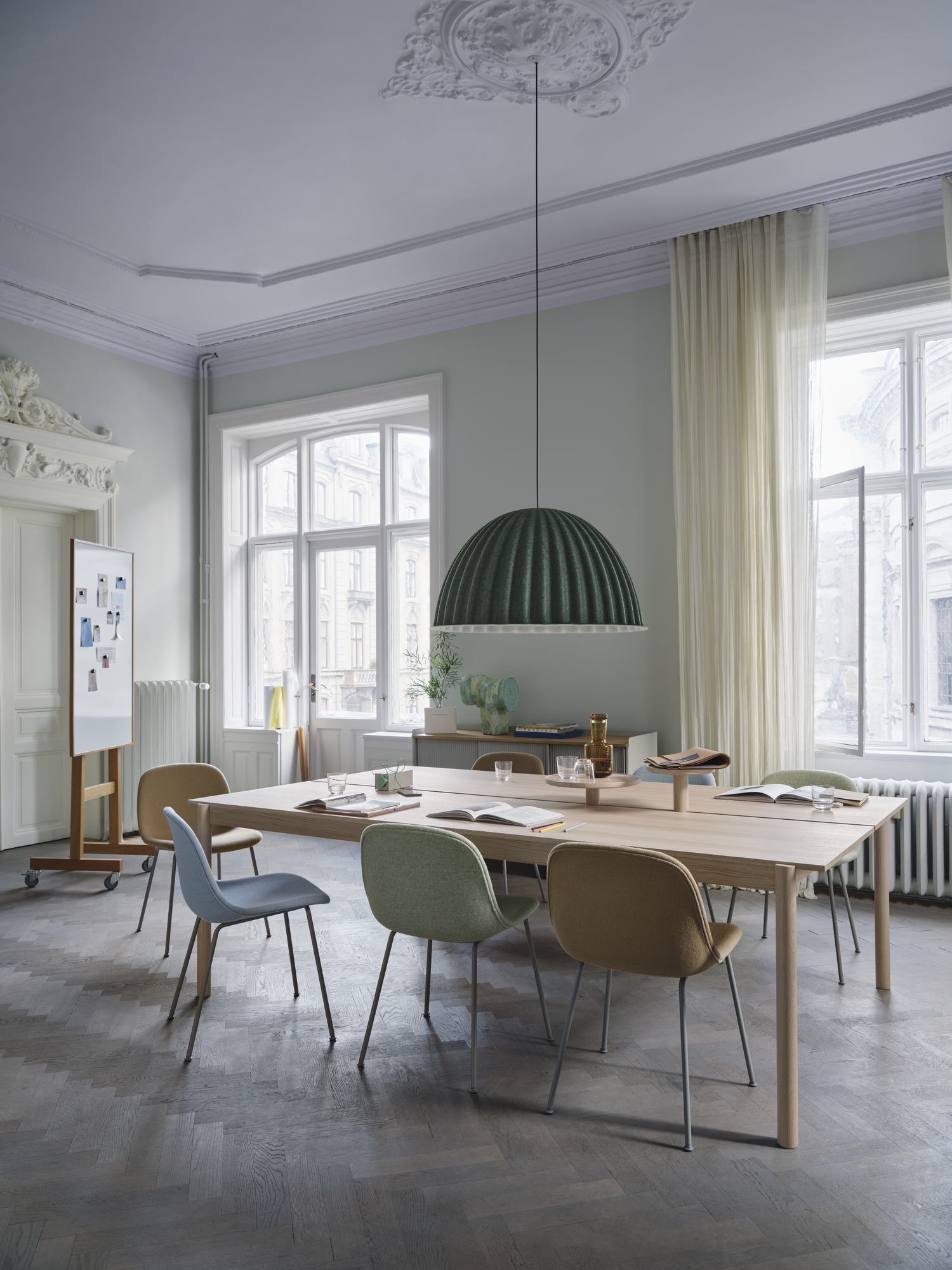 Linear System Table in Oak Veneer/Oak - Under The Bell Pendant Lamp Ø82 cm in Dark Green - Fiber Side Chair Tube Base in Fiord 721 & Hallingdal 224 & Divina MD 913 - Enfold Sideboard in Oak/Grey - Ridge Vase H16,5 cm in White - Raise Carafe in Burnt Orange - Raise Glasses in Clear - Linear System Tray Ø24 & Ø36 cm in Oak
