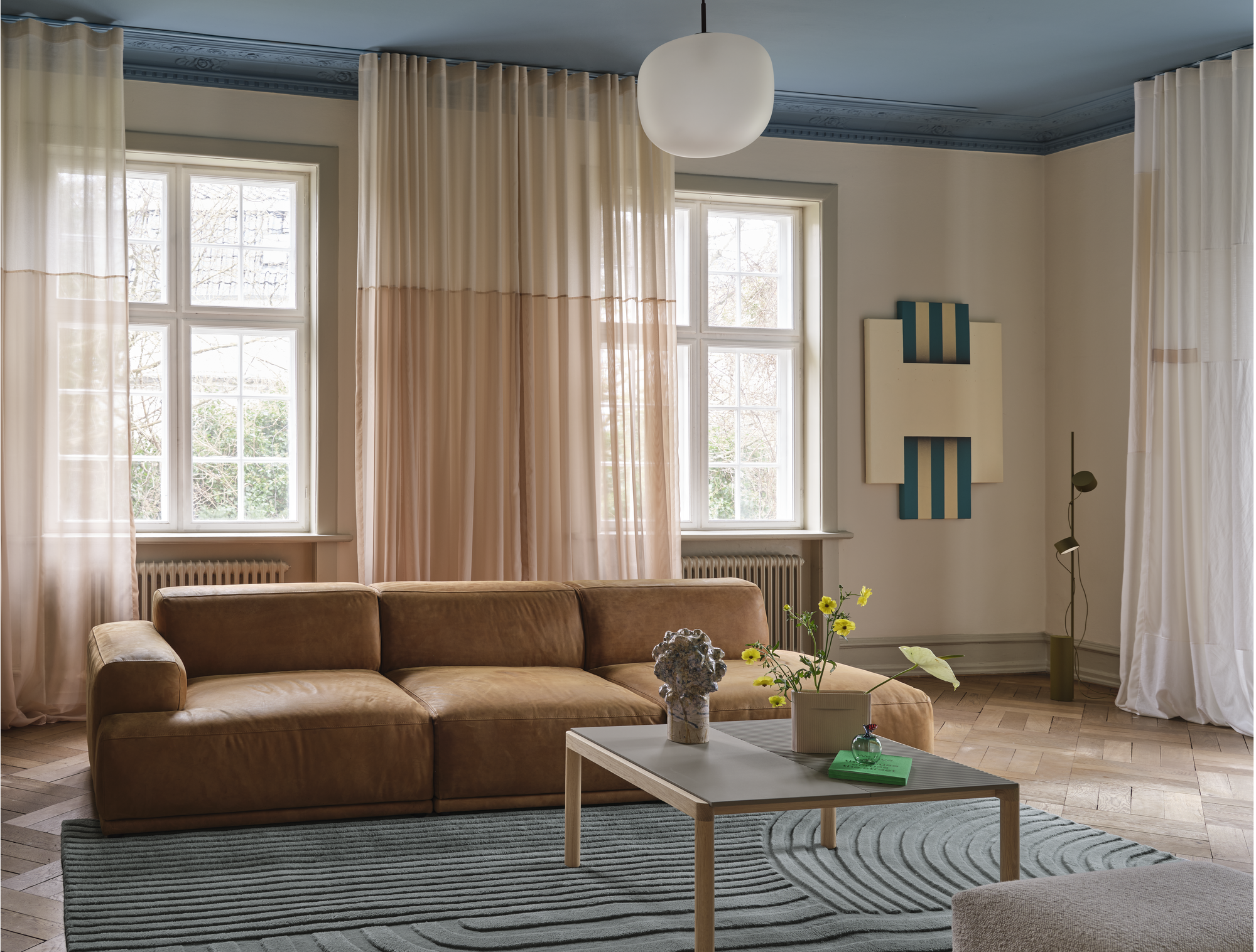 Connect Soft Modular Sofa in Grace Leather Cognac - Couple Coffee Table in Taupe - Echo Pouf in Hearth 7 - Relevo Rug in Sage Green - Post Floor Lamp in Brown Green - Rime Pendant Lamp Ø37 cm