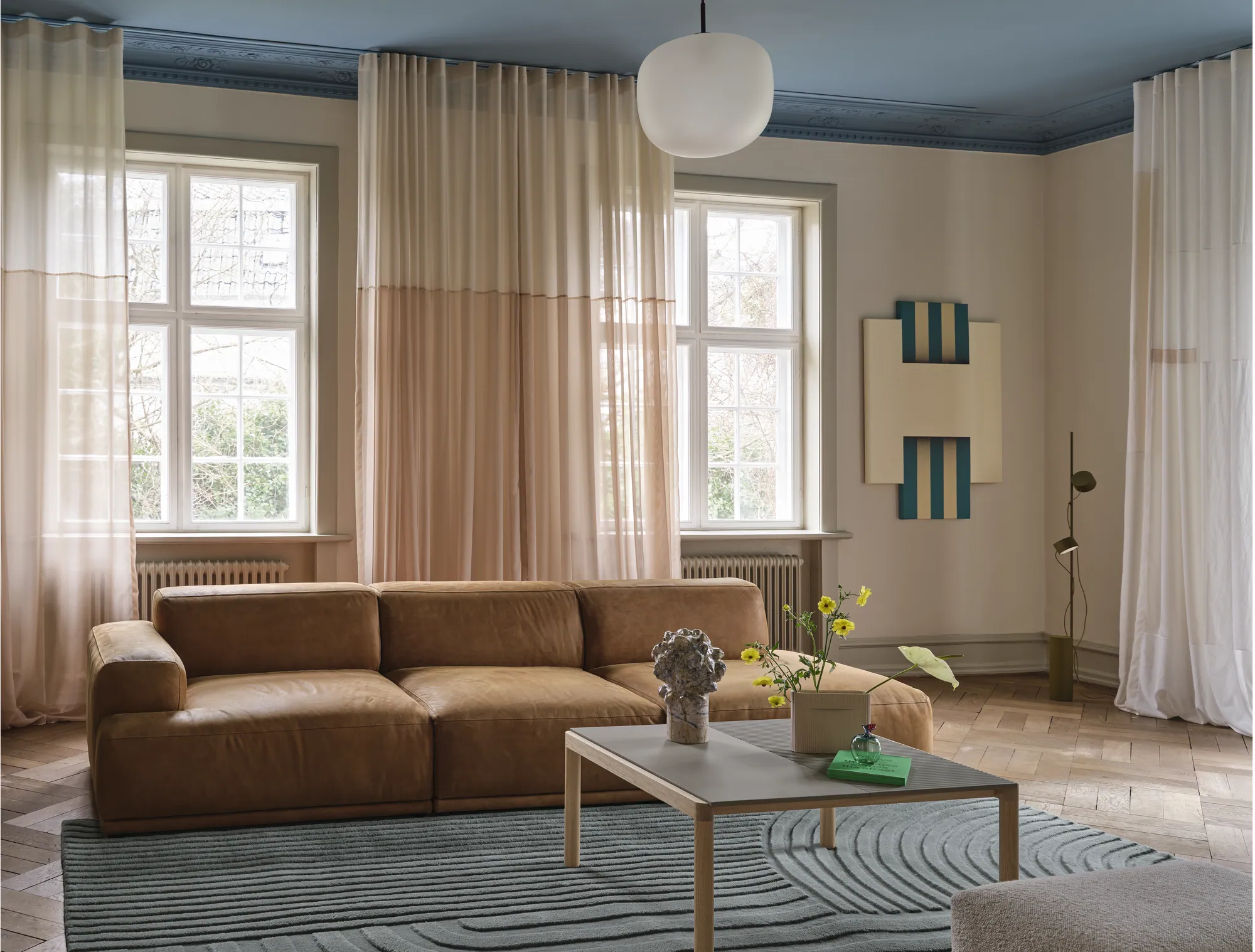 Connect Soft Modular Sofa in Grace Leather Cognac - Couple Coffee Table in Taupe - Echo Pouf in Hearth 7 - Relevo Rug in Sage Green - Post Floor Lamp in Brown Green - Rime Pendant Lamp Ø37 cm