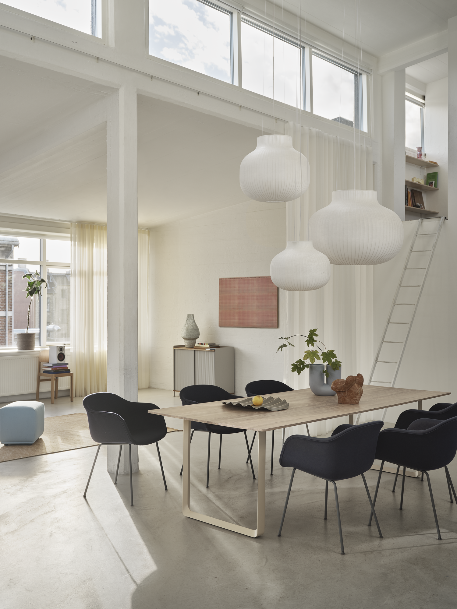 Strand Pendant Lamp Ø80 cm, Ø60cm, & Ø45 cm, Fiber Armchair Tube Base in Anthracite Black/Balder 792, 70/70 Table 255x108 cm in Oak/Sand, Enfold Sideboard in Grey, Ply Rug 170x240 cm in Burnt Orange, Echo Pouf in Steelcut 820, Kink Vase in Light Blue, Wave Tray
