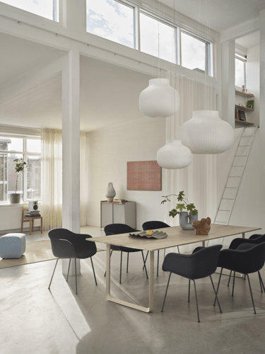 Strand Pendant Lamp Ø80 cm, Ø60cm, & Ø45 cm, Fiber Armchair Tube Base in Anthracite Black/Balder 792, 70/70 Table 255x108 cm in Oak/Sand, Enfold Sideboard in Grey, Ply Rug 170x240 cm in Burnt Orange, Echo Pouf in Steelcut 820, Kink Vase in Light Blue, Wave Tray