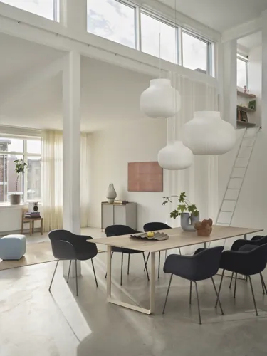 Strand Pendant Lamp Ø80 cm, Ø60cm, & Ø45 cm, Fiber Armchair Tube Base in Anthracite Black/Balder 792, 70/70 Table 255x108 cm in Oak/Sand, Enfold Sideboard in Grey, Ply Rug 170x240 cm in Burnt Orange, Echo Pouf in Steelcut 820, Kink Vase in Light Blue, Wave Tray