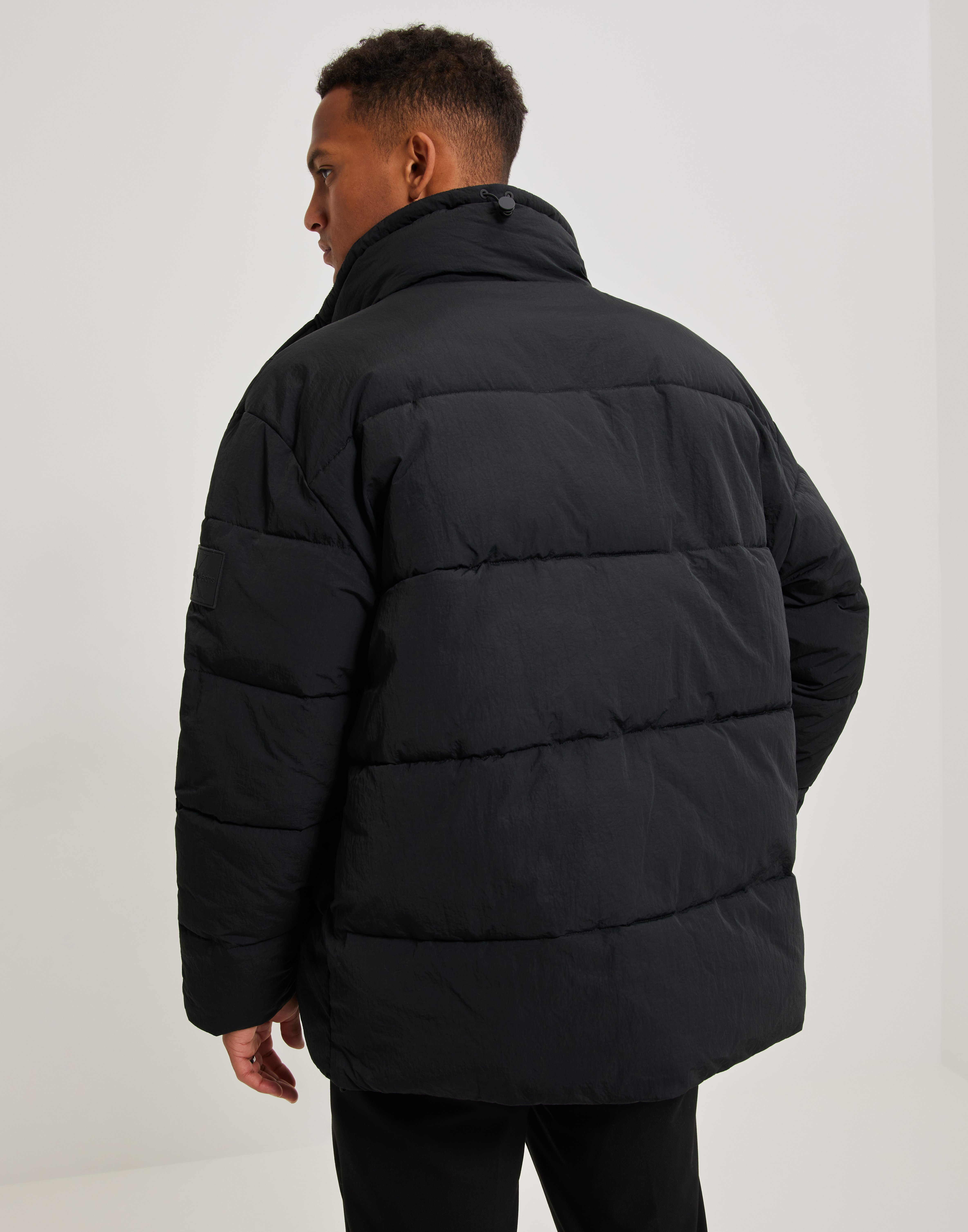 Buy Calvin Klein Jeans BADGE OVERSIZED PUFFER Black NLYMAN