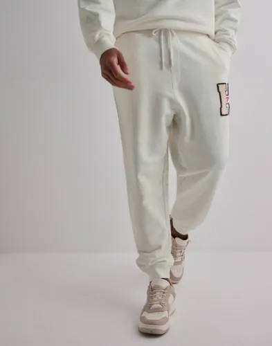 Tommy Jeans mjukisbyxor i vitt frotté med knytband och logga på sidan