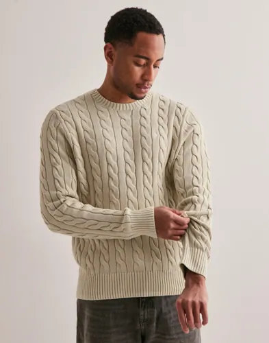 Beige kabelstickad tröja från Polo Ralph Lauren med rundhals och logga
