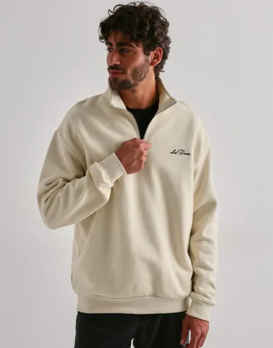 Les Deux half-zip sweatshirt i beige med logga på bröstet