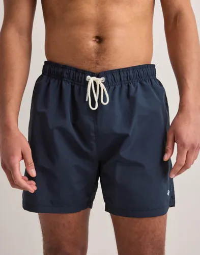Blå badshorts från Gant med broderad logga på benet