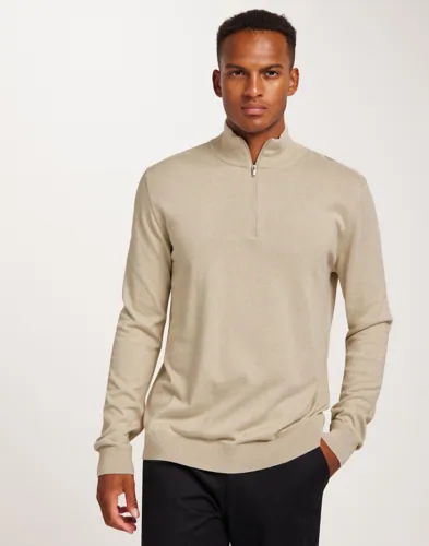 Beige half-zip-cardigan från Selected med dragkedja i halsen och ribbmuddar