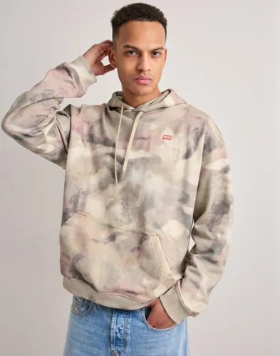 Beige hoodie från Diesel med luva, framfickor och logga på bröstet