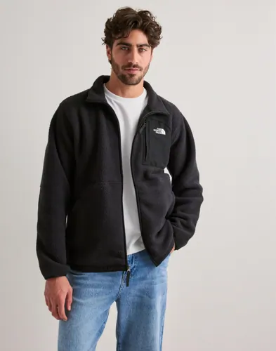 Svart fleecejacka från The North Face med dragkedja och broderad bröstlogga
